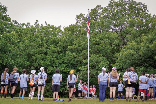 Girl Scouts and their leaders at Greenfield Farm Day Camp reciting the Girl Scout Promise at the end of their last morning flag ceremony. Photo/ Evan Kennemer